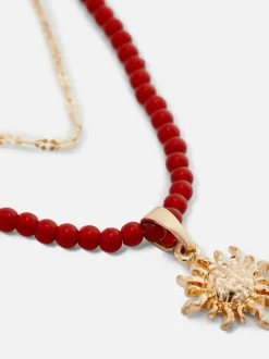 Naszyjnik z koralików z wisiorkiem z motywem słońca