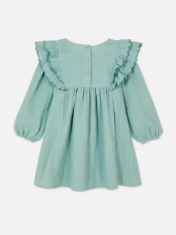 Sukienka z falbaną w kwiaty z muszelkowym brzegiem