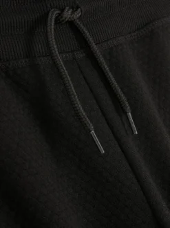 Teksturowane spodnie dresowe ściągane sznurkiem