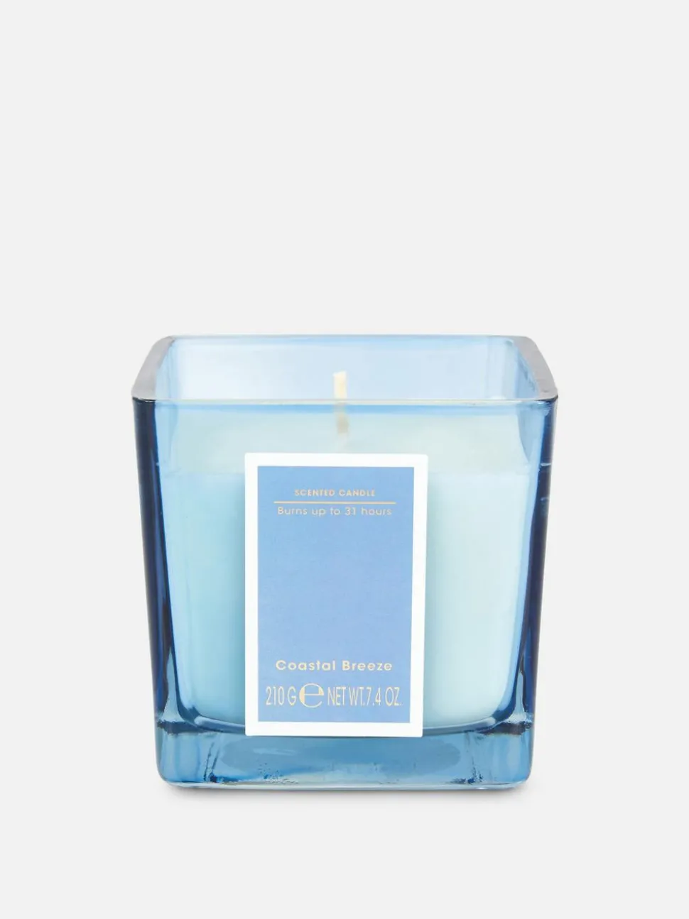 Świeca w kwadratowym pojemniku z barwionego szkła