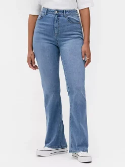 Modelujące jeansy o kroju slim z rozszerzaną nogawką