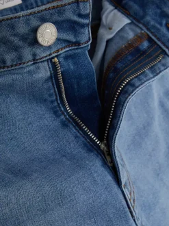 Modelujące jeansy o kroju slim z rozszerzaną nogawką