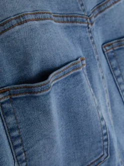 Modelujące jeansy o kroju slim z rozszerzaną nogawką