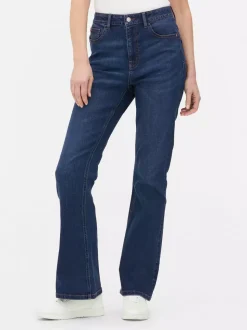 Modelujące jeansy o kroju slim z rozszerzaną nogawką