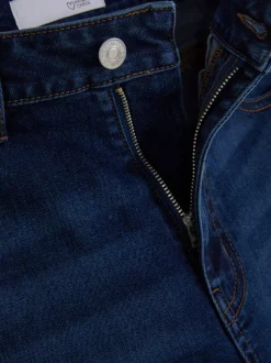 Modelujące jeansy o kroju slim z rozszerzaną nogawką