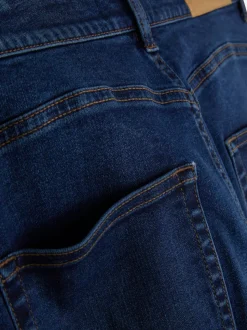 Modelujące jeansy o kroju slim z rozszerzaną nogawką