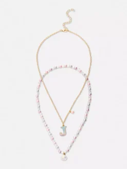 Naszyjniki z inicjałem i muszelką, 2 szt.